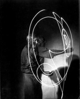 Multiple exposure of artist Pablo Picasso using flashlight to make light drawing in the air.  (Photo by Gjon Mili//Time Life Pictures/Getty Images)