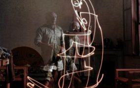 Triple exposure of artist Pablo Picasso drawing w. light at his home in Vallauris.